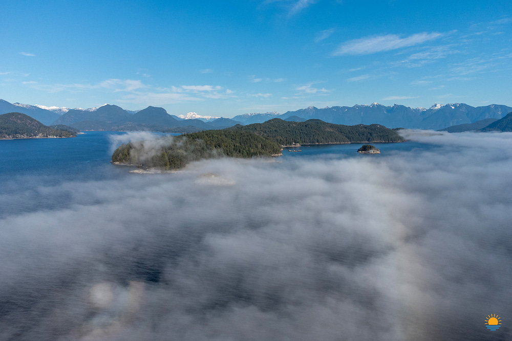 Keats Island on a foggy day as seen from above and looking back towards the North Shore Mountains.